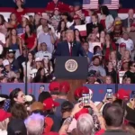 Woman in Epstein Files Shirt Punched at Trump Ohio Rally as President Mocks Her Weight.