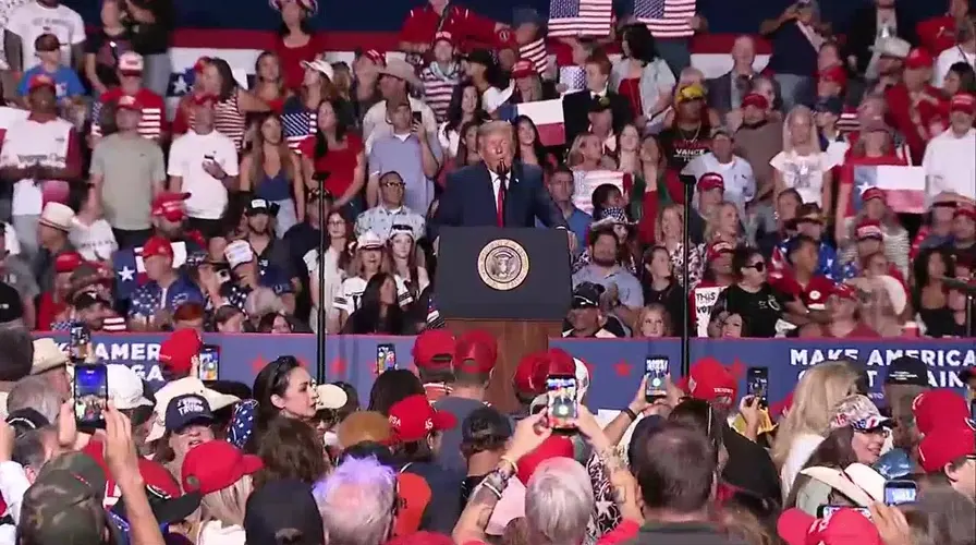 Woman in Epstein Files Shirt Punched at Trump Ohio Rally as President Mocks Her Weight.